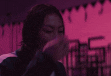 a person with blood on their shirt is covering their face