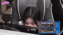 a girl is playing a video game with a screen that says ' pc ' on it