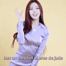 a woman with red hair is wearing a purple shirt that says haz un corazon si eres de jade on the bottom