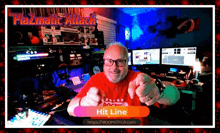 a man giving a thumbs up in front of a screen that says hit line