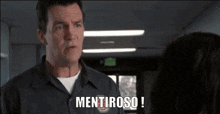 a man is talking to a woman in a hallway and the word mentiroso is on the screen