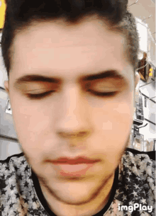 a close up of a man 's face with the words imgplay visible