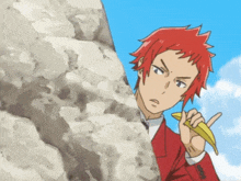 a man with red hair is holding a banana peel and pointing
