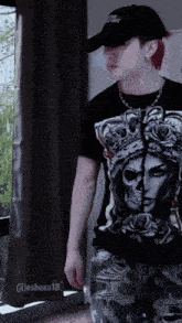 a man wearing a hat and a shirt with a skull on it