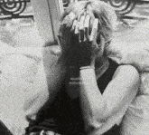 a black and white photo of a woman covering her face with her hands and the words millionstars below her