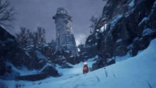 a person standing in the snow near a tower