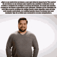 a man with a beard is smiling and standing in front of a white background