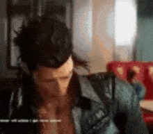 a blurry picture of a man in a denim jacket with the words " i 'm sorry " on the bottom right