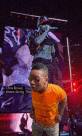 a young boy stands in front of a screen that says chris brown