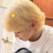 a close up of a person 's head with a yellow sticker on it .