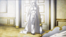 a woman in a white dress stands in a hallway