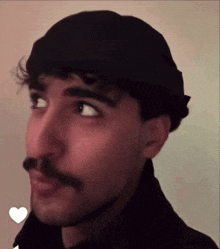 a man with a mustache wearing a black hat and a black jacket