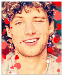 a painting of a smiling man with hearts around his face and the words cb designs on the bottom