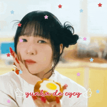 a girl holding a fried egg with the name yunha de cycy above her