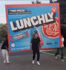 a man carrying a box of lunchly feastables