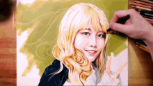 a drawing of a woman with blonde hair is being drawn by a person