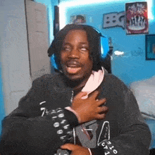 a man wearing headphones is making a funny face while standing in a room .