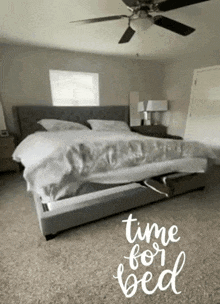 a bedroom with a bed and a ceiling fan and the words time for bed written on the floor