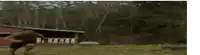 a blurry picture of a man jumping over a pile of dirt .