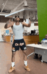 a man wearing shorts that say dodge is dancing in a room