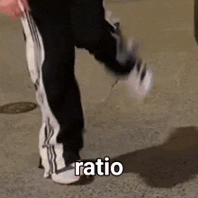 a person is walking down the street with the word ratio written on their feet .