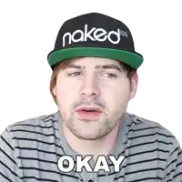 a man wearing a naked 100 hat and a striped shirt says okay