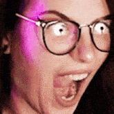 a woman wearing glasses and making a funny face