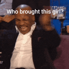 a man in a suit is laughing with the words who brought this girl behind him