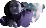 a woman in a purple sweater is laying in a cloud .
