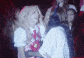 two girls are hugging each other and one is wearing headphones