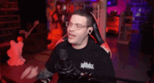 a man is sitting in a chair in front of a microphone and eating something .