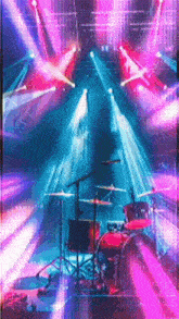 a drum set is on a stage with a lot of lights