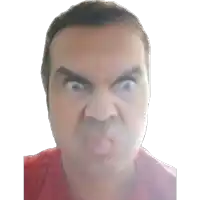 the man is wearing a red shirt and making a funny face .