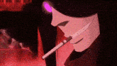a close up of a person smoking a cigarette in a dark room .