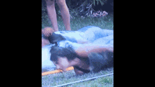 a man is wrapped in a plastic bag and being splashed by water