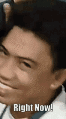a close up of a man 's face with the words `` right now ! ''