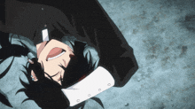 a man with long black hair is laying on his back