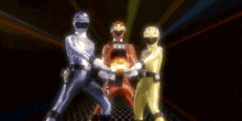 a group of skeletons are standing in a dark room with a glowing object in the background .