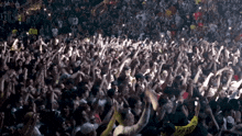 a crowd of people with one wearing a yellow shirt that says ' i love you ' on it