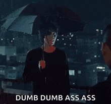 a man holding an umbrella in the rain with the words dumb dumb ass ass above him .