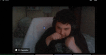 a computer screen shows a person sitting in a chair with expander written on the bottom right
