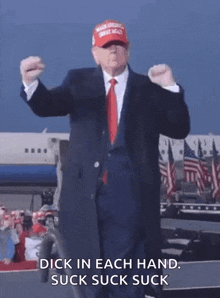a man in a suit and tie is dancing in front of an airplane and says dick in each hand suck suck suck .