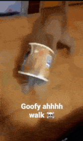 a cup on a table that says goofy ahhh walk
