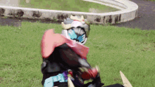a person in a costume is sitting on the grass .