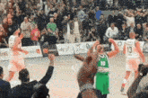 a basketball player with the number 10 on his jersey is celebrating