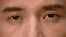 a close up of a man 's eyes with tears coming out of them