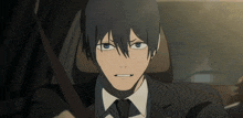a man in a suit and tie is sitting in a car with his mouth open
