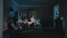 a couple of people sitting on a couch watching tv