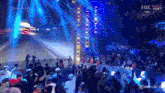a crowd of people watching a wrestling match on the fox network