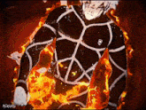 a man in a black and white shirt is surrounded by flames .